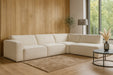 Canapé d’angle modulable Orlando en tissu texturé beige dans un intérieur moderne et chaleureux